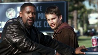 (L to R) Denzel Washington as Alonzo Harris and Ethan Hawke as Jake Hoyt, standing next to a car, in Training Day, one of the best Netflix movies