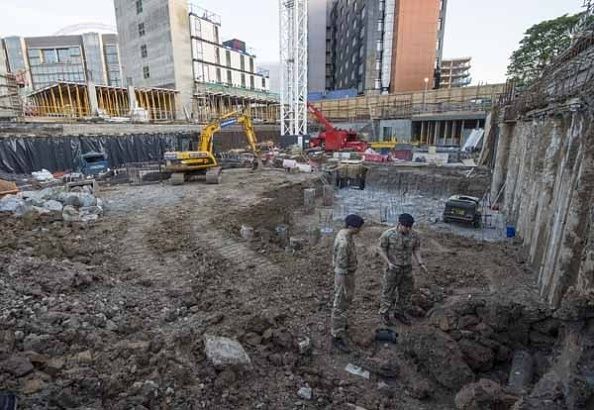 Experts inspect the unexploded bomb