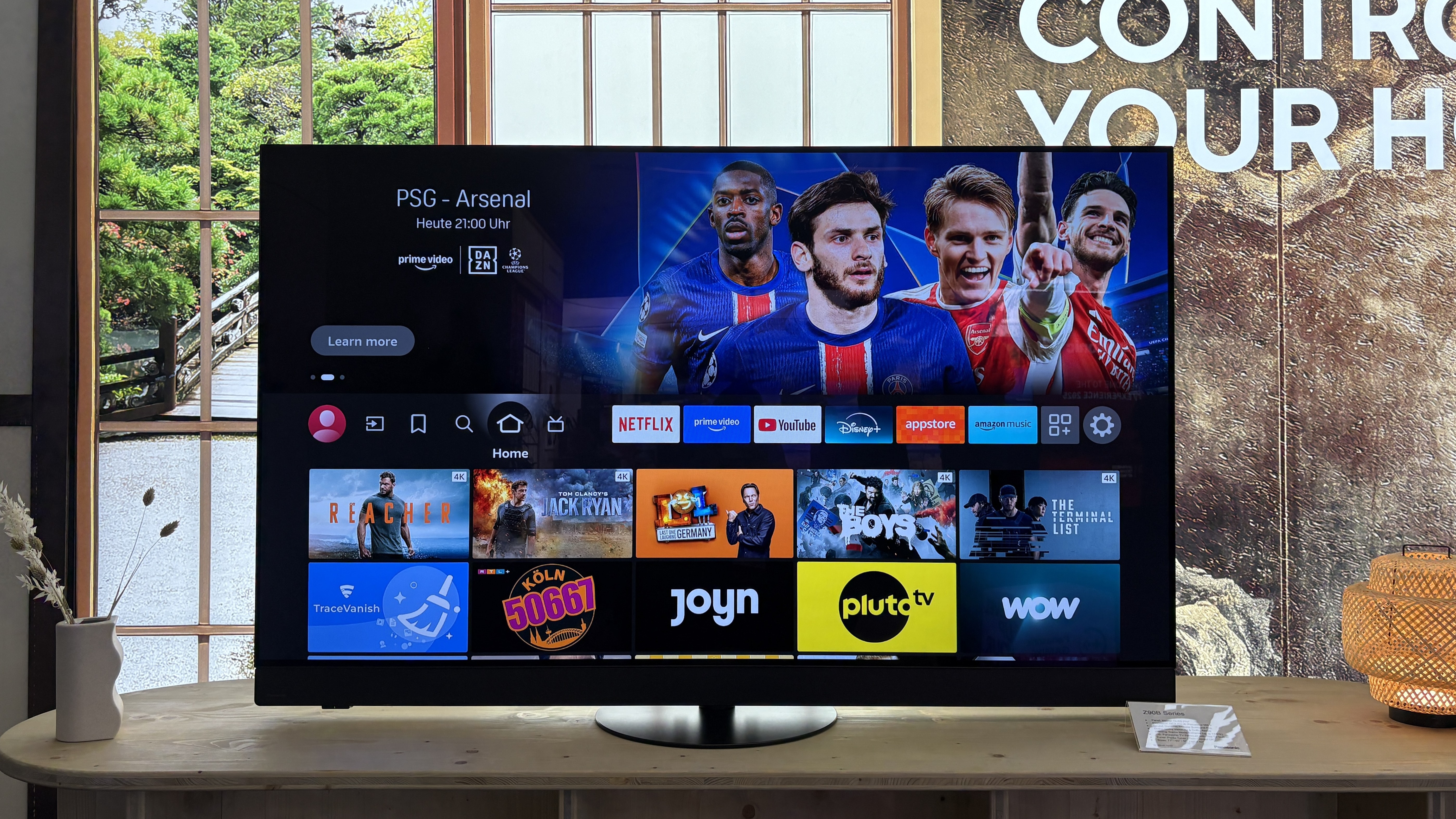 Panasonic Z90B OLED TV on a wooden side table.
