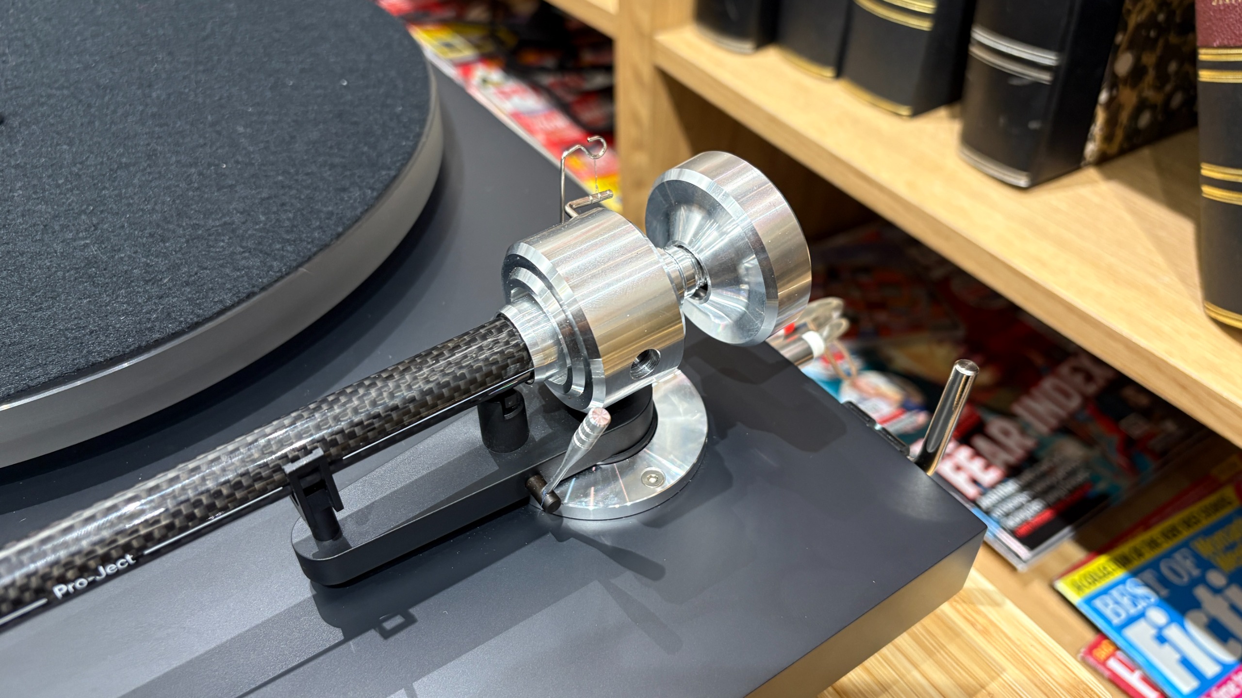 Pro-Ject Debut Reference 10 turntable on wooden shelf