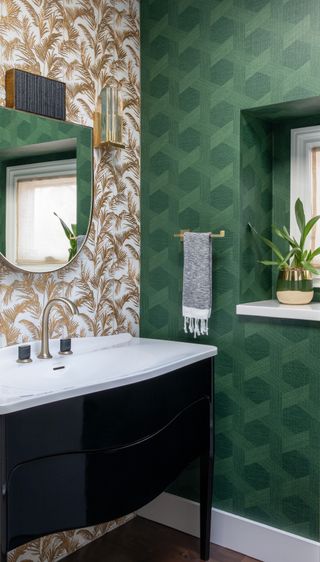 powder room with black vanity, green wallpaper, gold fern wallpaper