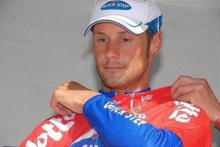 Tom Boonen doesn't look too happy to receive the red jersey again.