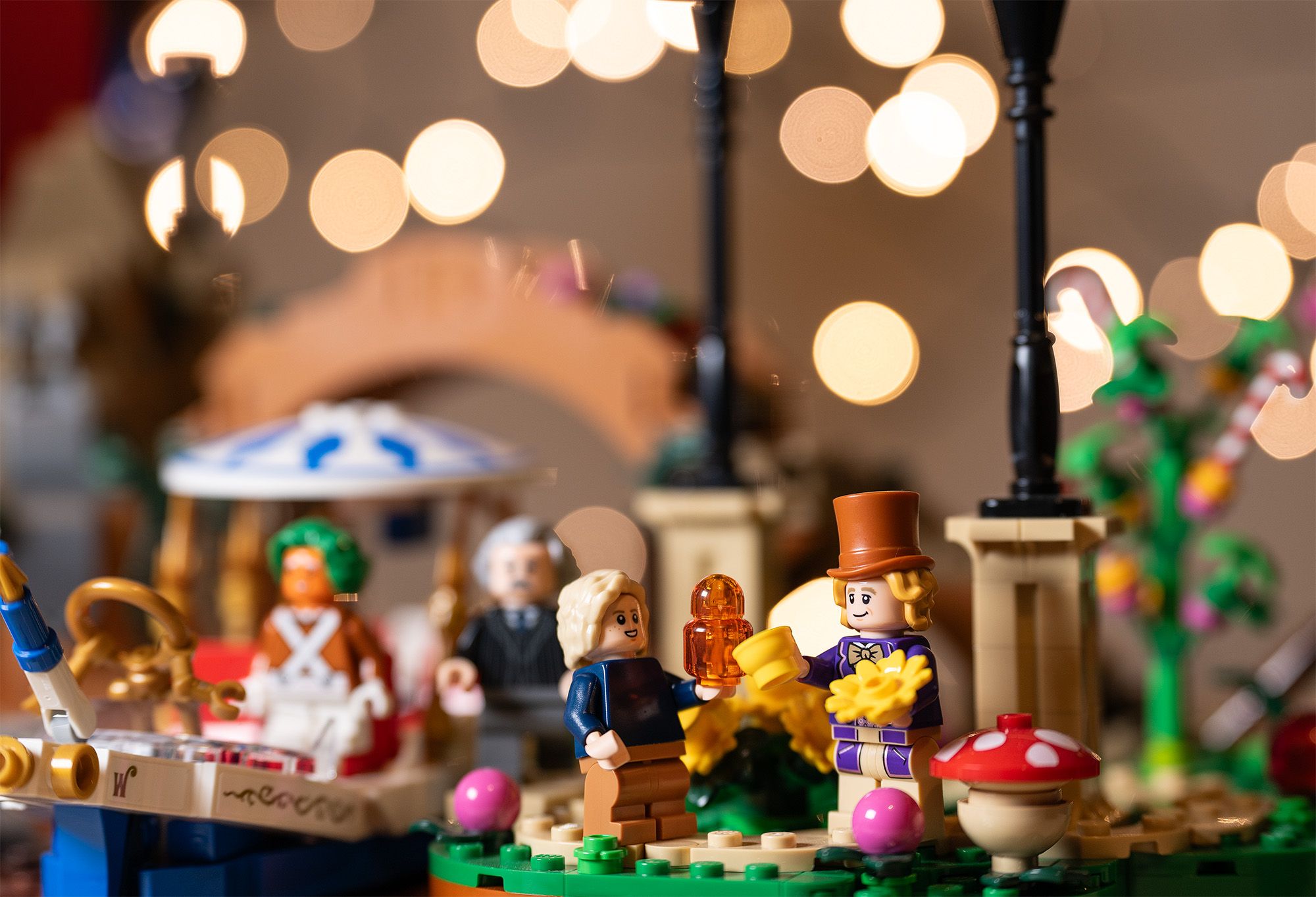 Colorful Lego Willy Wonka set with three characters and round discs of bokeh in the background