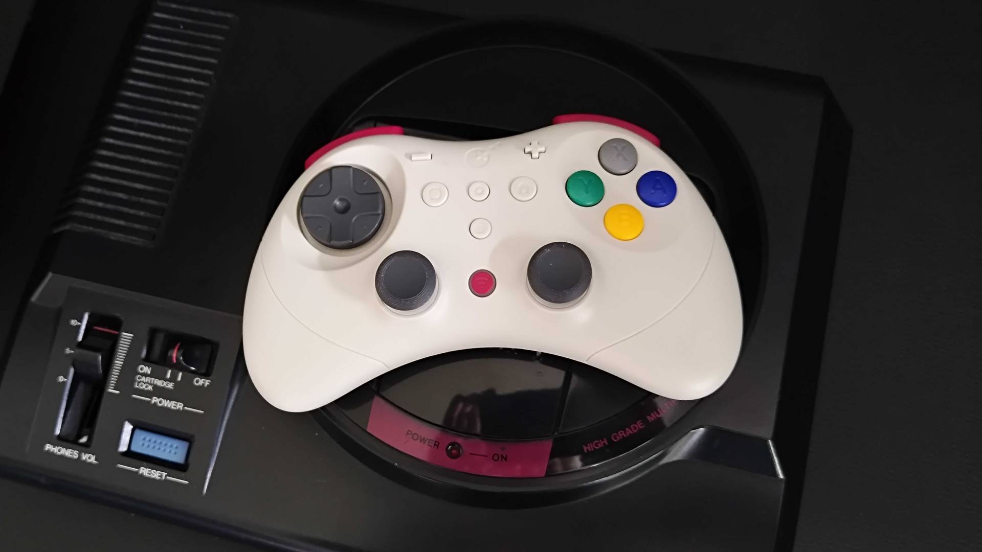 Gulikit Elves 2 Pro on top of Japanese Sega Mega Drive console.