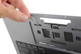 Macbook Pro 14-inch 2021 teardown by iFixit, revealing how to get under the touchpad and access the pull tabs to remove some of the batteries