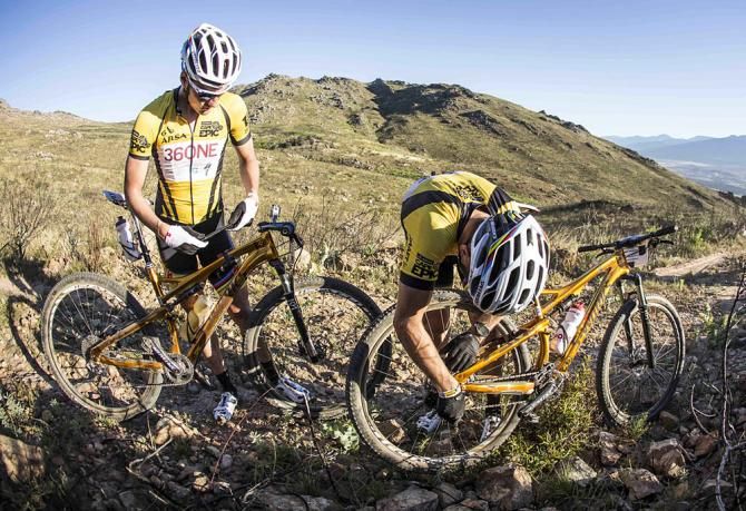 Christoph Sauser(Switzerland) of Burry Stander-Songo replaces his wheel after a blowout