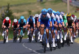 Team BikeexchangeJayco team riders lead the pack during the 13th stage of the 109th edition of the Tour de France cycling race 1926 km between Le Bourg dOisans in the French Alps and SaintEtienne in central France on July 15 2022 Photo by Thomas SAMSON AFP Photo by THOMAS SAMSONAFP via Getty Images