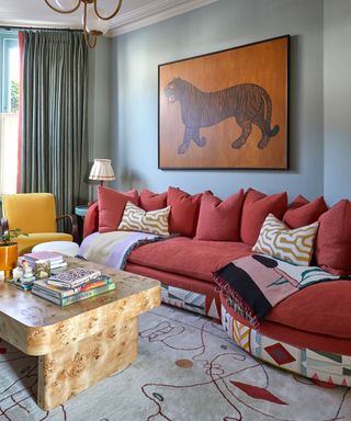Retro living room with an orange sofa and patterned rug