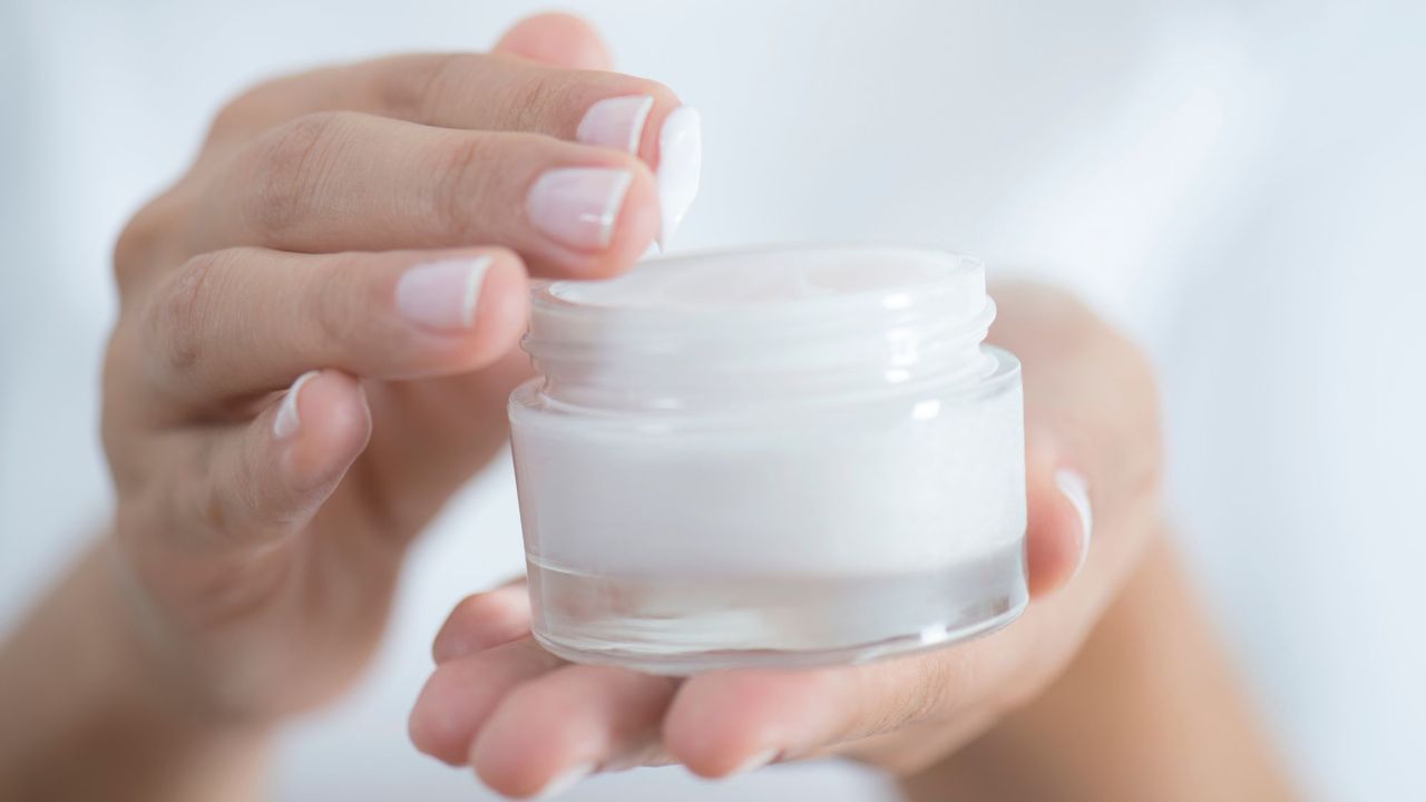 Rich creams - image of a woman dipping her fingers into a pot of cream