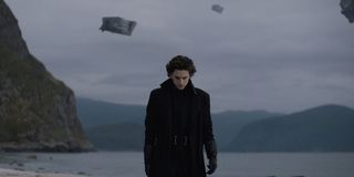 Dune Timothee Chalamet stands on the shore with ships taking off