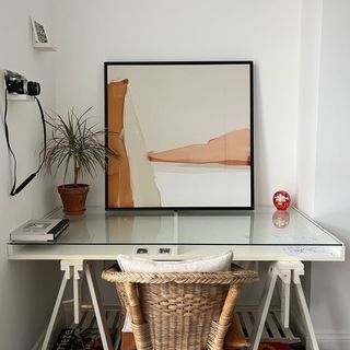 Rust abstract canvas art leaning on desk in bedroom