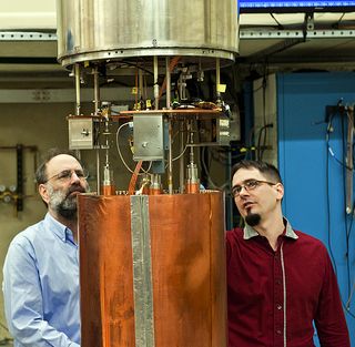 University of Washington physicists Gray Rybka (right) and Leslie Rosenberg examine the primary components of the ADMX detector.