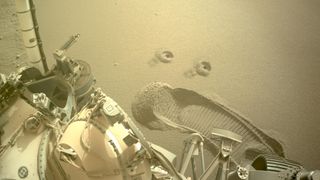 A image taken by NASA's Perseverance rover shows two holes drilled to collect samples of regolith in early December.