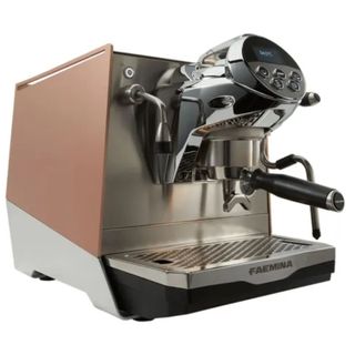 The Faemina coffee machine in a copper finish on a white background