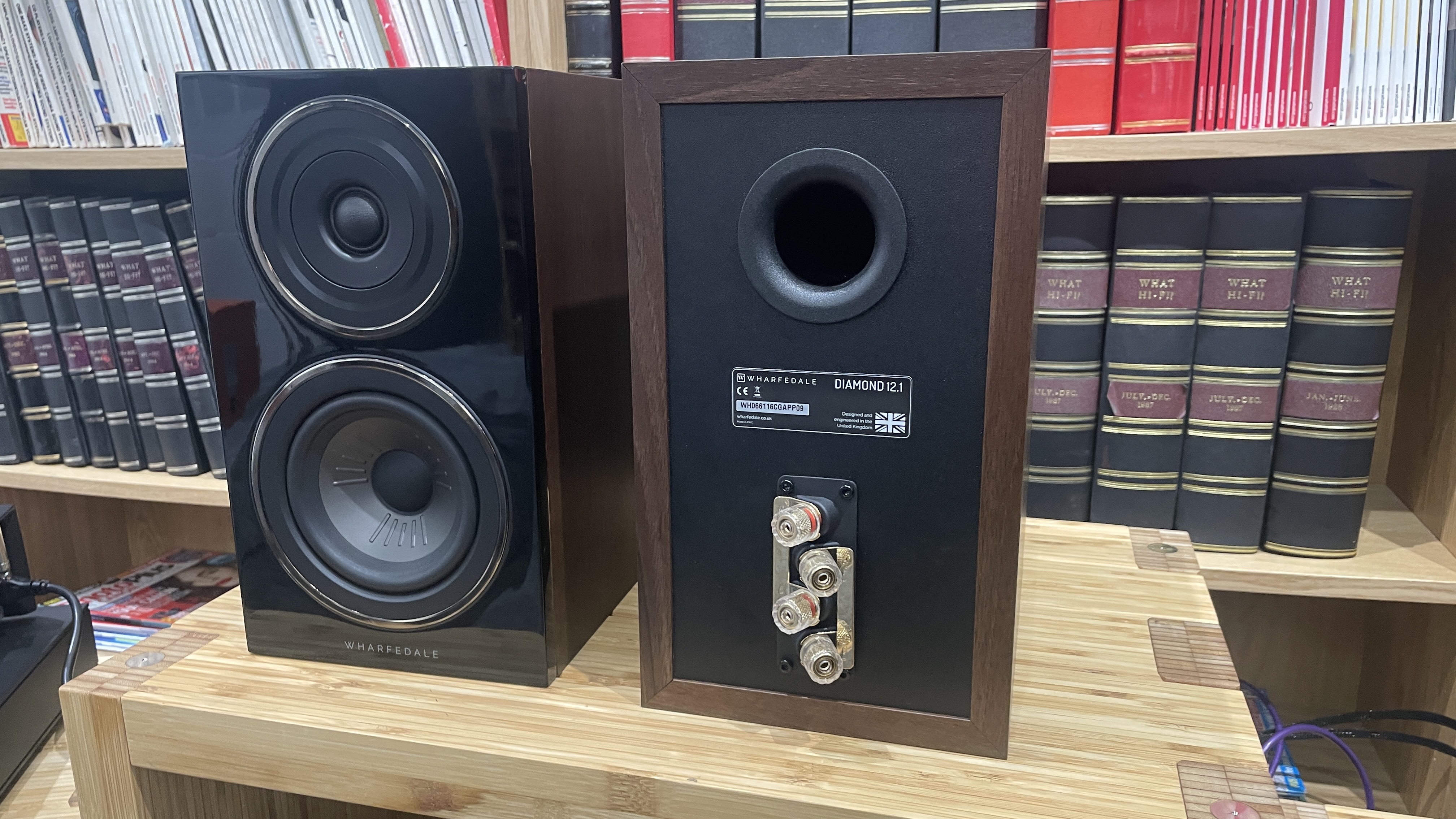 Wharfedale Diamond 12.1 stereo speakers in walnut veneer finish on a wooden rack
