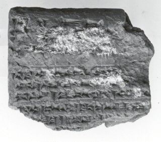 A black and white photo of a cuneiform tablet