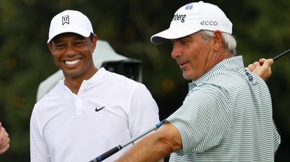 Fred Couples and Tiger Woods share a laugh on the golf course