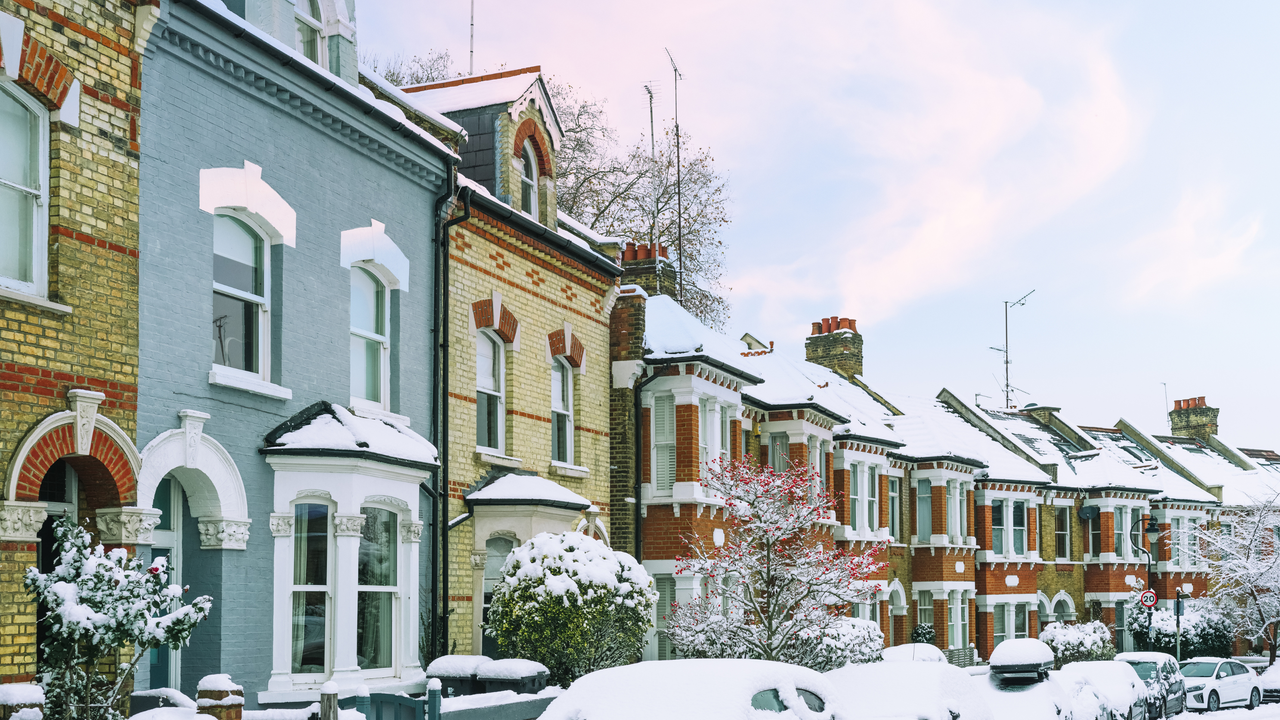 snow-topped roofs in a london street