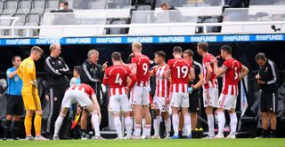 Chris Wilder talks to his players during a drinks break at St James' Park