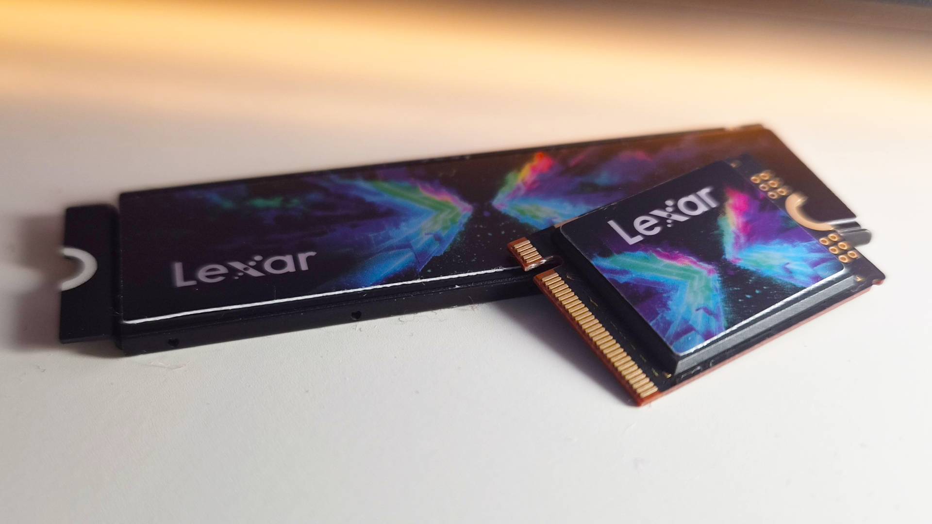 Photo of the Lexar Play X SSD on a white gaming desk.
