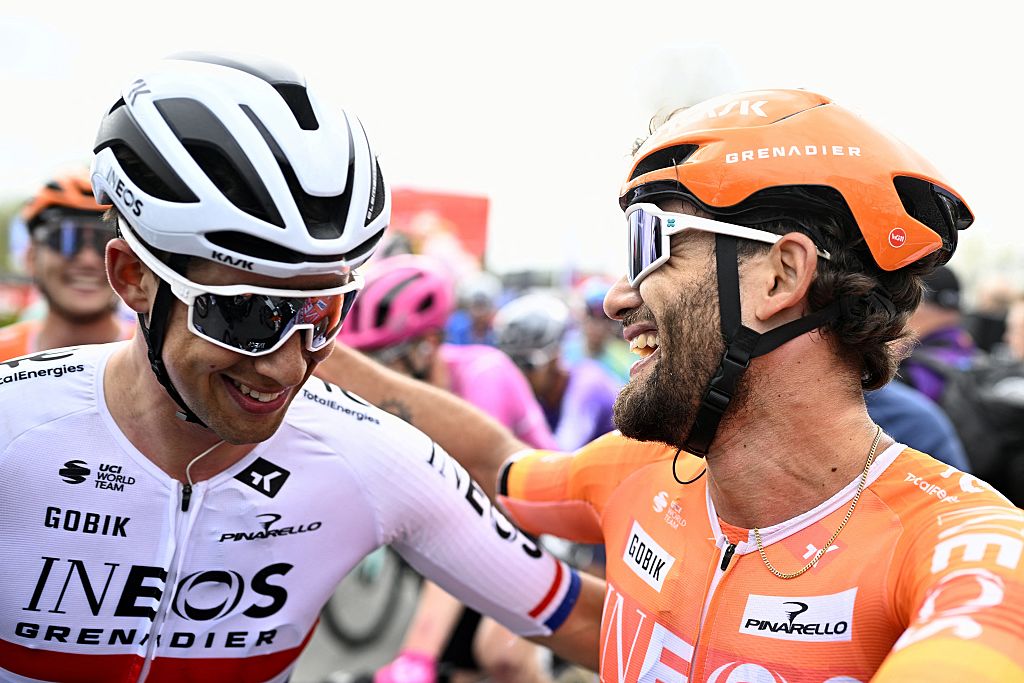 INEOS Grenadiers' British rider Samuel Watson (L) congratulates INEOS Grenadiers's Italian rider Filippo Ganna after winning the men's elite race of the Dwars door Vlaanderen cycling event, 184.6km from Roeselare to Waregem on April 1, 2026. (Photo by JASPER JACOBS / BELGA / AFP) / Belgium OUT