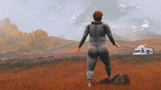 Nate in his gray onesie looks at an ice cream truck and a distant mountain