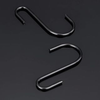 two back metal S hooks laid down on a black background