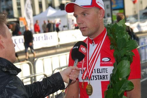 Men's time trial champion Rasmus Quaade talks to the media.