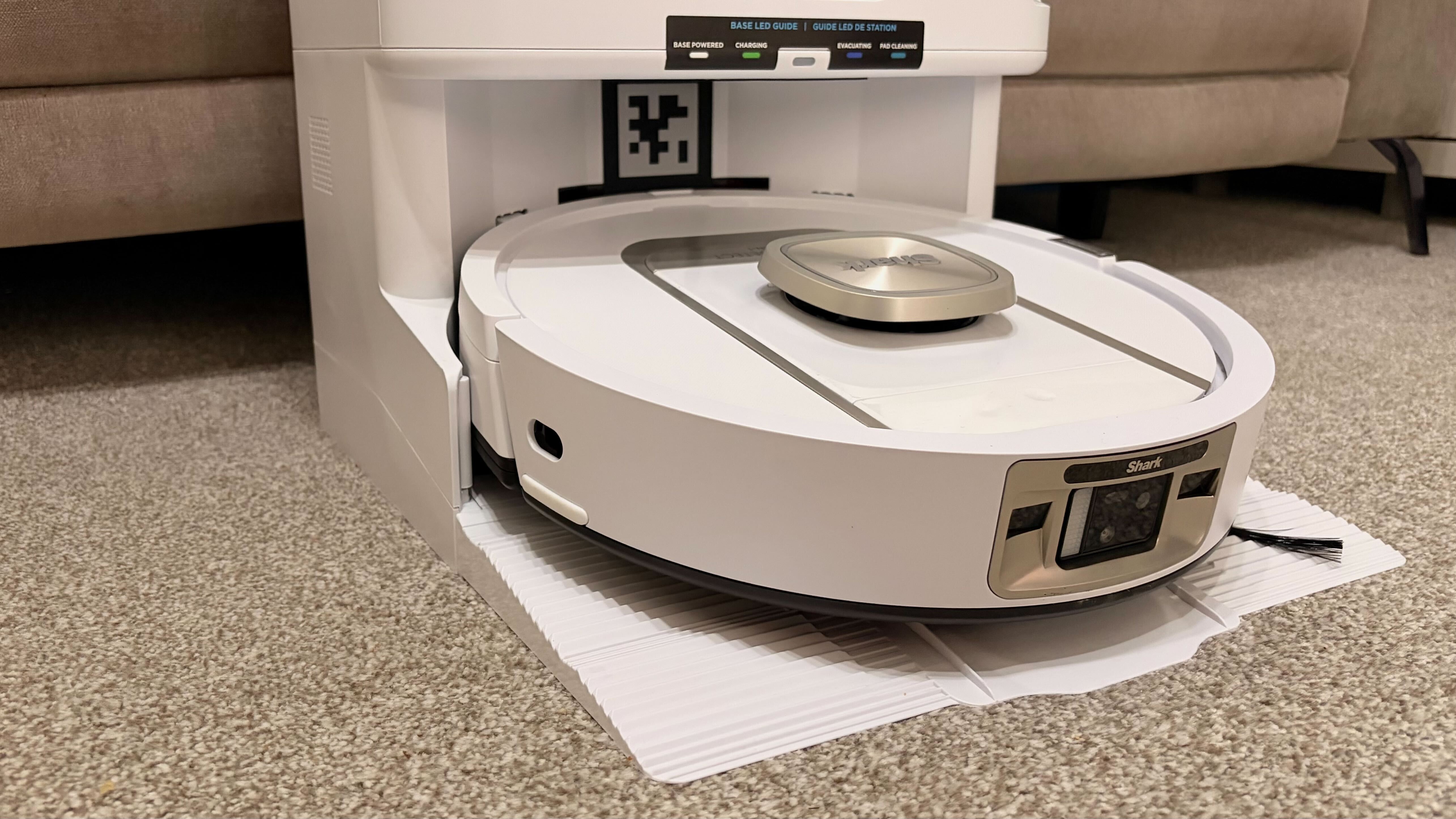 Shark PowerDetect 2-in-1 ThermaCharged NeverTouch photographed on a carpet with docking station