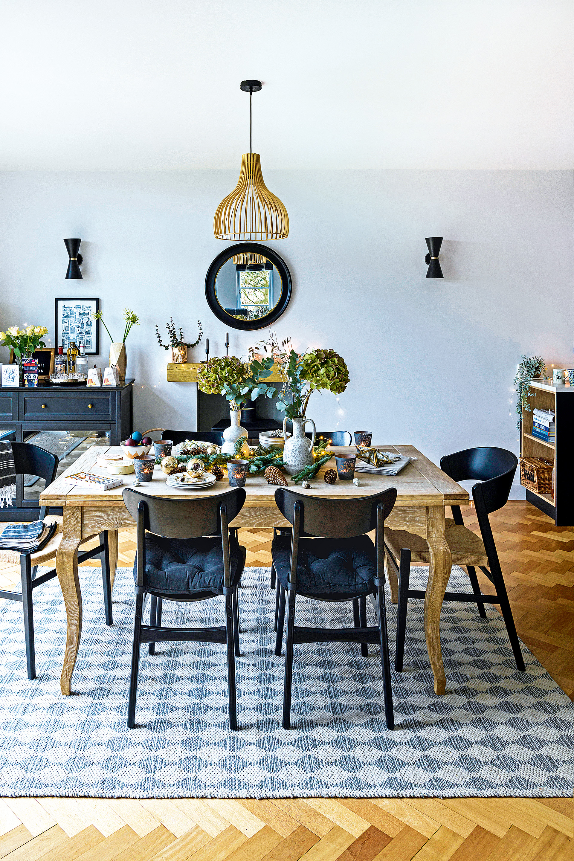 christmas setting with dining table in modern open plan room with white walls