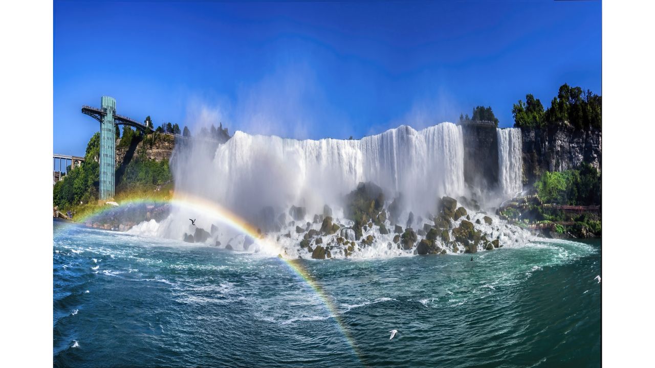 A panorama squeezing in all of the detail of the American Falls up close and sapphire blue skies above