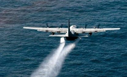 A plane spreads dispersant over the Gulf.