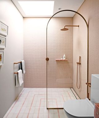 Shower room with pink tiles and curved screen
