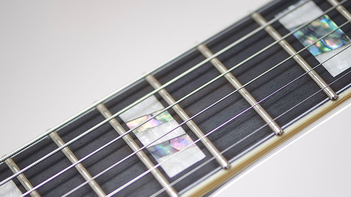 The JSM10's ebony fingerboard is ornamented with classy, retro-looking abalone/mother-of- pearl block inlays