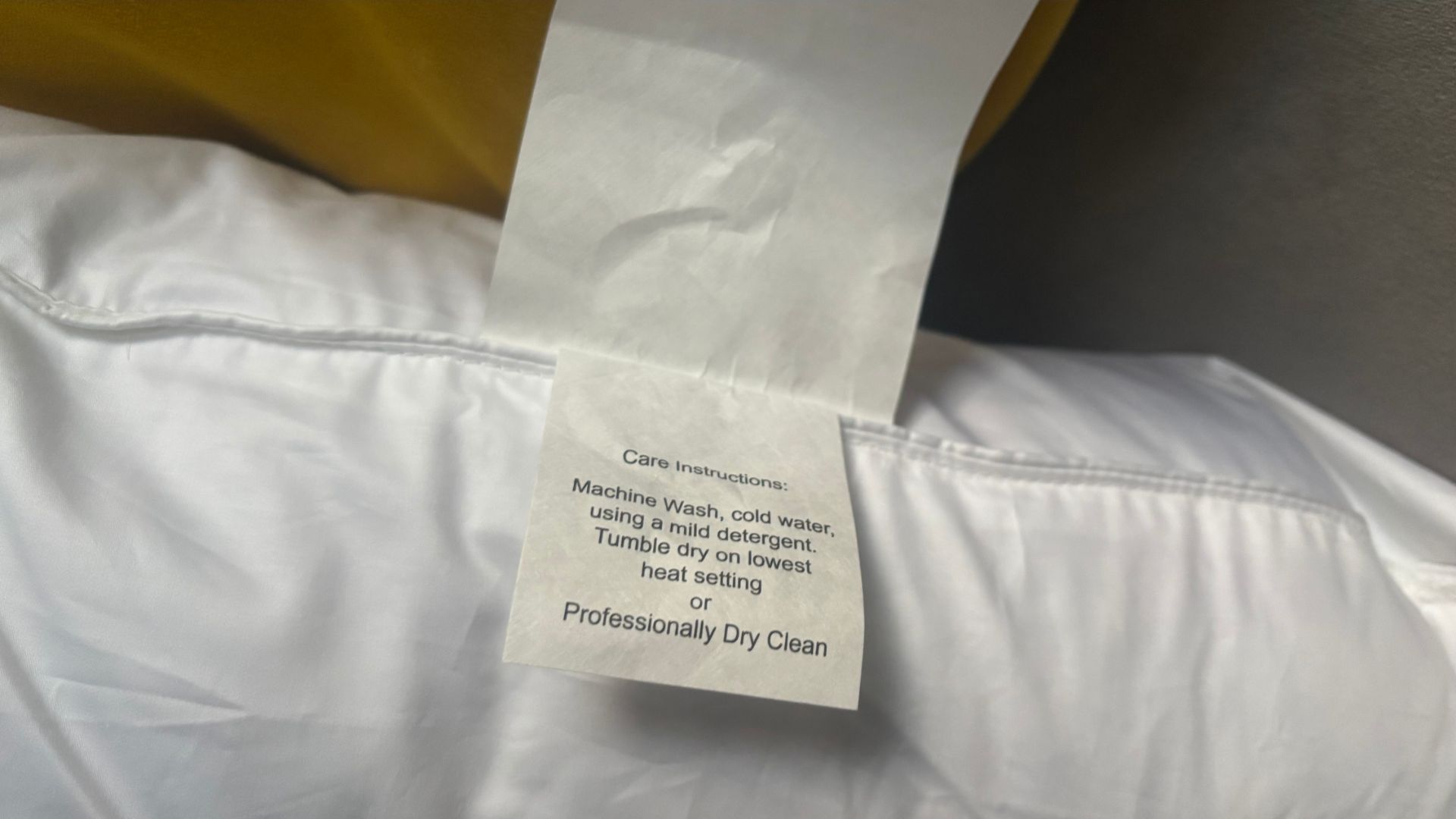 The care instruction label of the Helix Down and Feather Pillow.