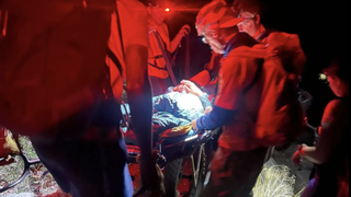 Inyo County Search and Rescue attend to the bitten hiker