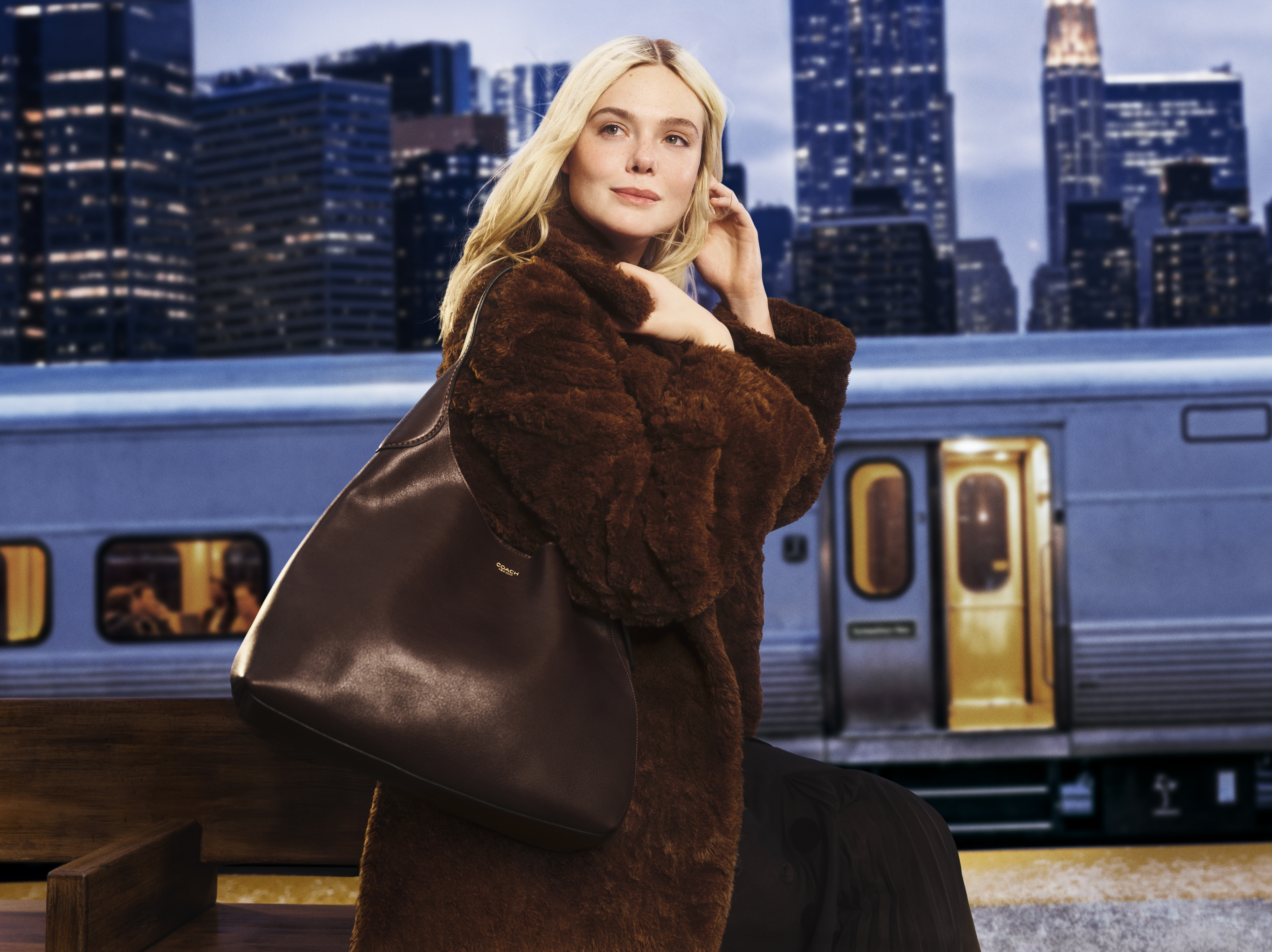 Elle Fanning carrying a Coach bag and wearing a teddy bear coat