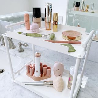Tiered cosmetics organizer on bathroom vanity