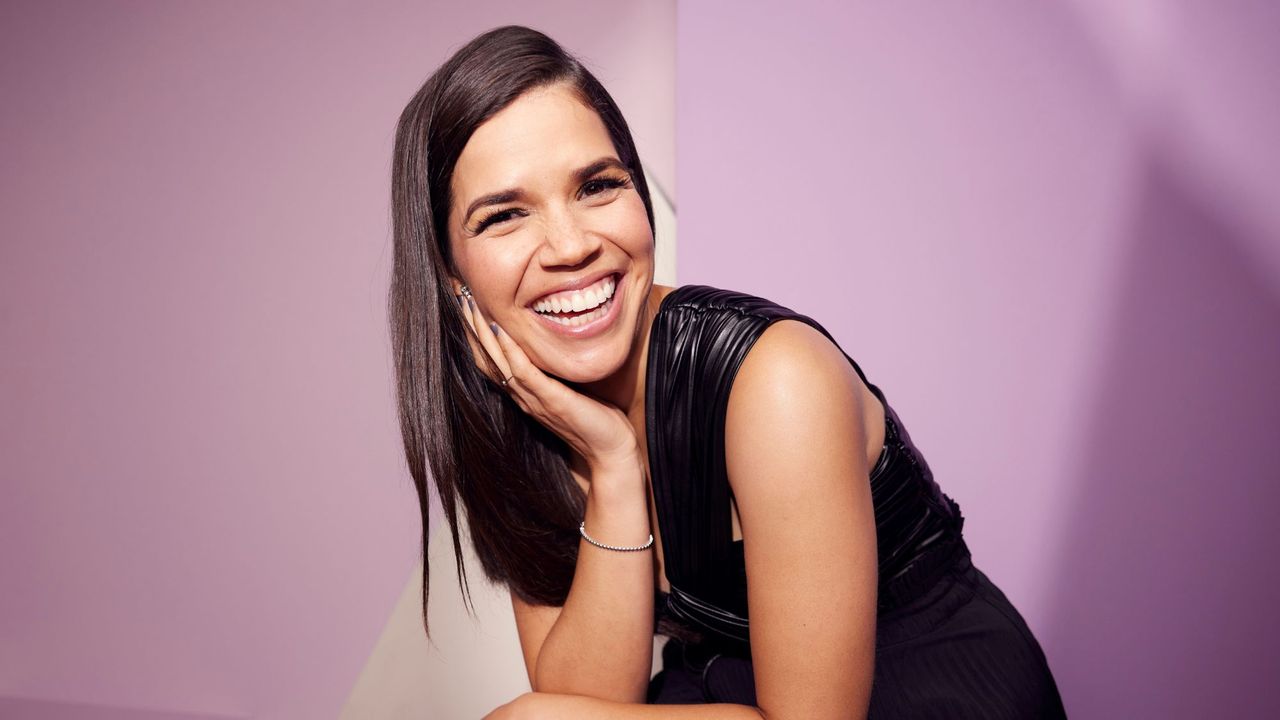 America Ferrera poses at the IMDb Official Portrait Studio against a pink background