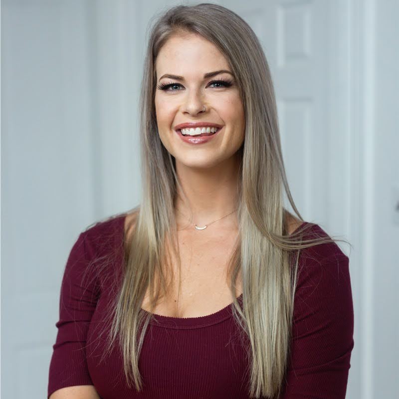Head and shoulders of a smiling woman.