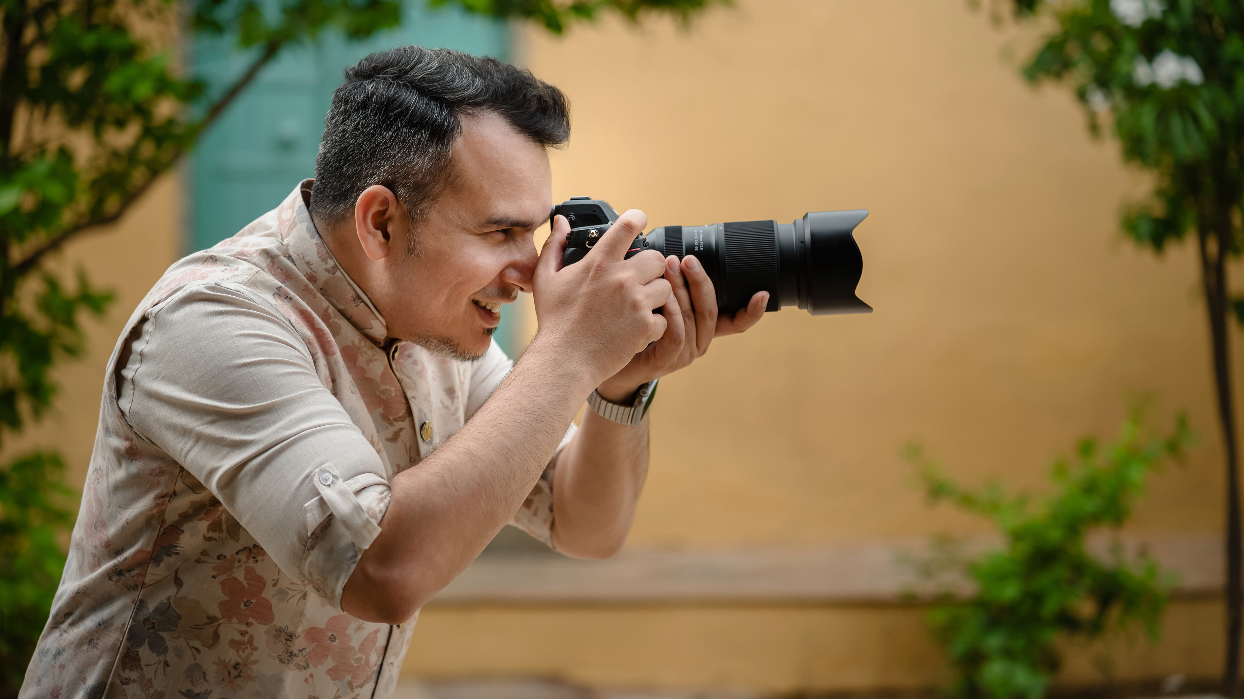 The Tamron 70180mm f/2.8 G2 lens in a person's hands