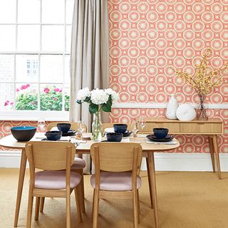 dining room with wallpaper on wall and dining table with chairs