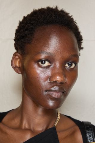 a model with the high shine spring 2025 beauty trend at prabal gurung