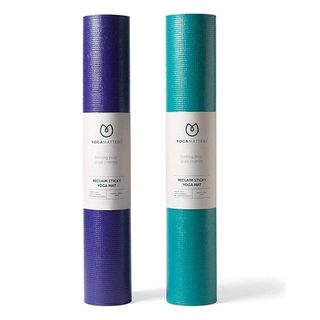 Two rolled-up yoga mats. A purple one on the left and a blue one on the right.