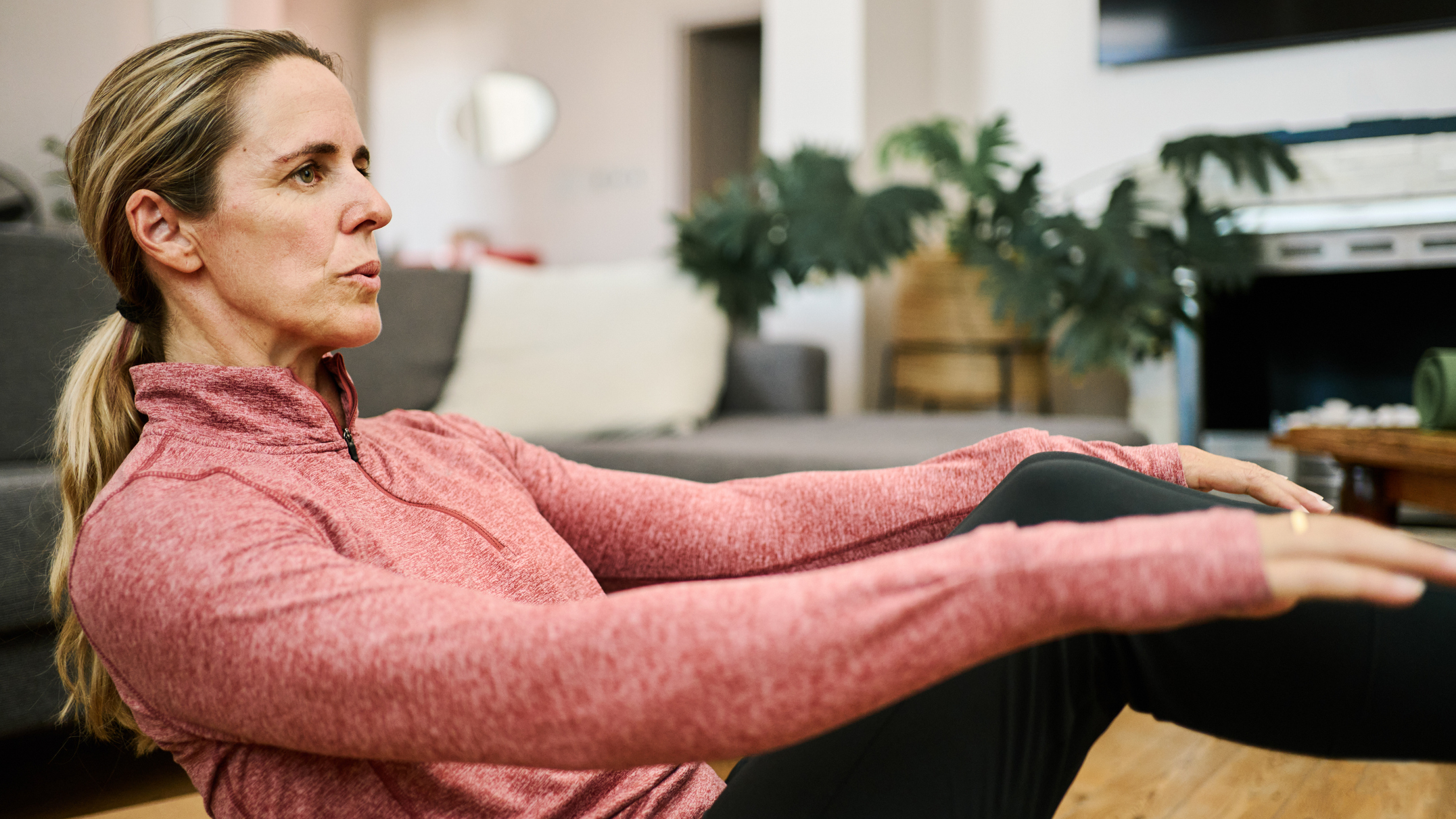 Woman in workout clothes exercising in a domestic setting