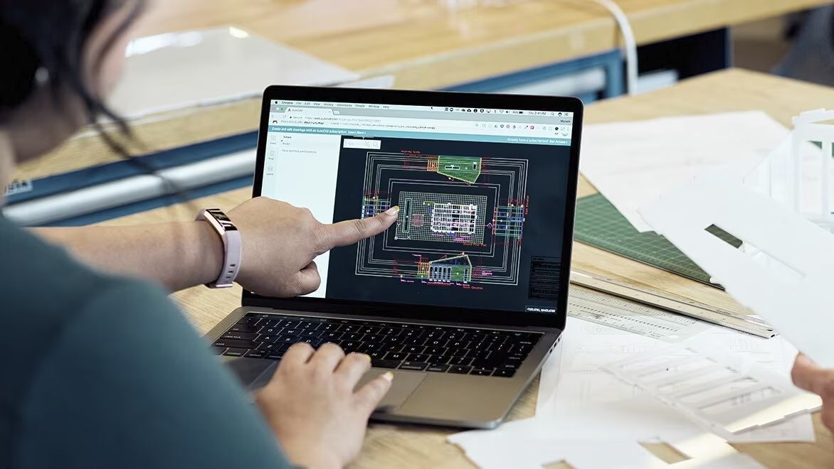 Man working at home using laptop near the big window. Remote work, online  job, work from home. Stock Photo