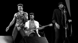 Singers and musicians Larry Blackmon, Aaron Mills and Tomi Jenkins of Cameo performs at the Chicago Theater in Chicago, Illinois in 1986.