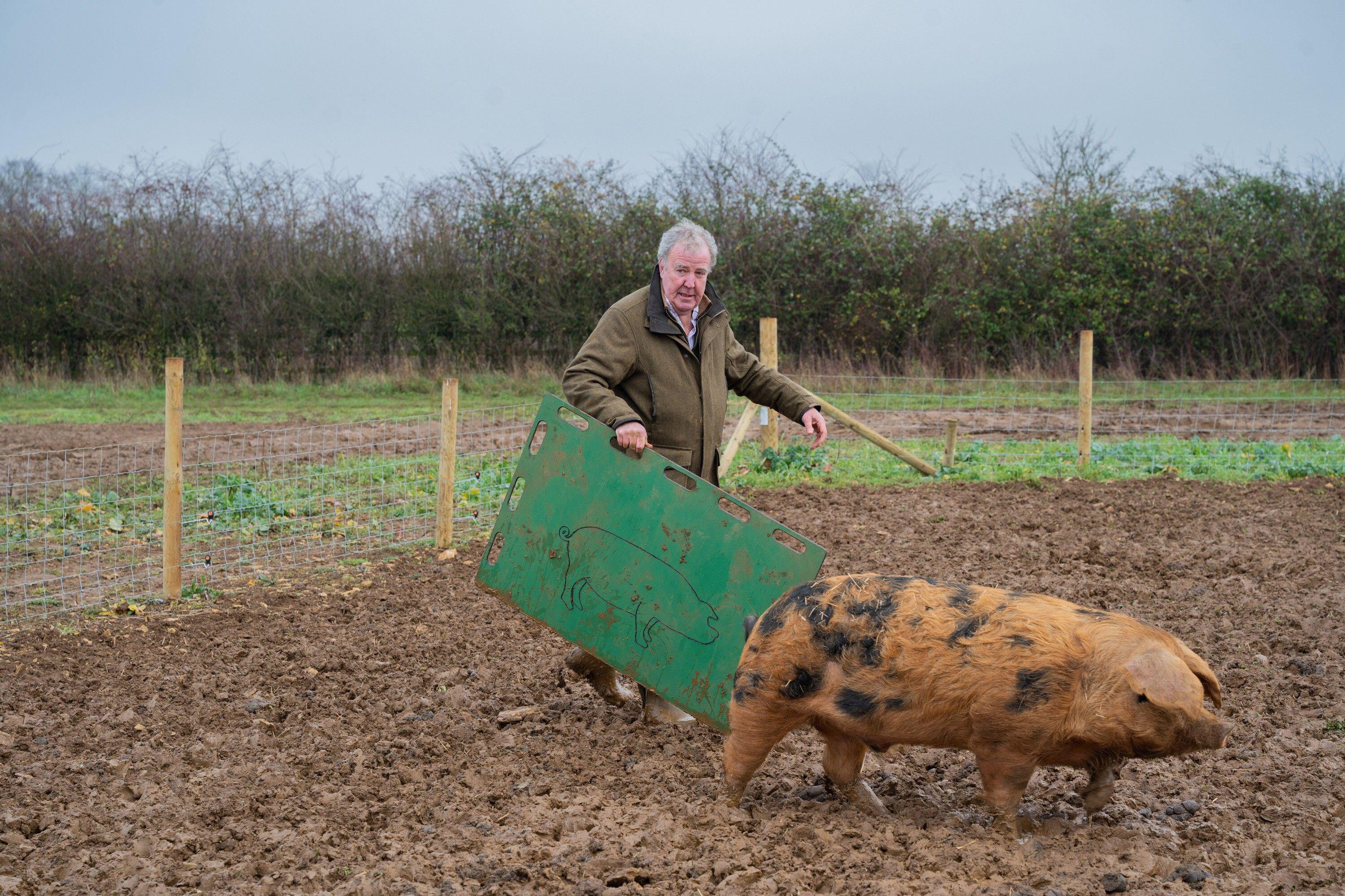 Jeremy Clarkson with a pig on Clarkson's farm