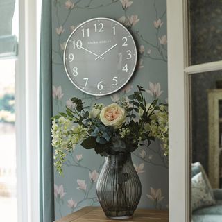room with grey floral wallpaper and watch