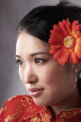 A Chinese woman in a traditional qipao dress.